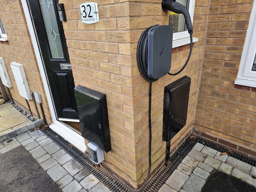 external ev charger fixed to a wall by the homeowners front door