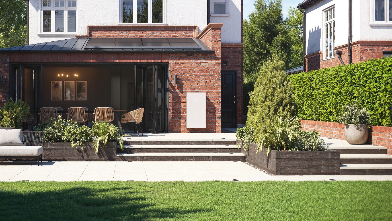 Tesla Powerwall mounted on a brick wall